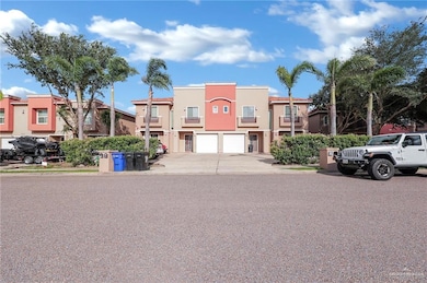 View of front of house with a garage, driveway, stucco siding, and a residential view
