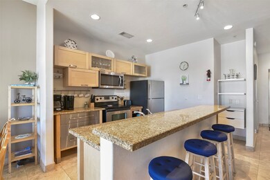The modern kitchen features a breakfast bar that c