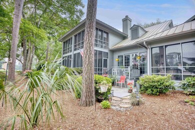 Back of house featuring a patio and a sunroom