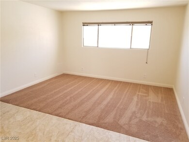 Carpeted empty room with baseboards