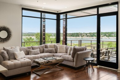 Living area featuring a water view, a wall of win