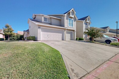 View of front property with a garage and a front y