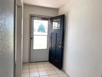 Doorway to outside featuring light tile patterned 