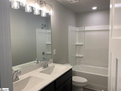 With dual rectangular vanities and upgraded lighti