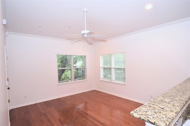 Unfurnished room with wood finished floors, crown
