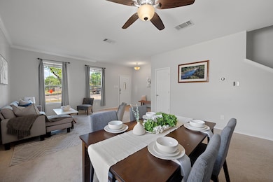 Dining space featuring light colored carpet, a ce