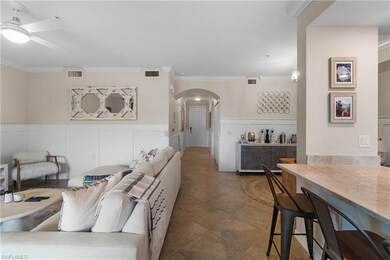 Tiled living room featuring ornamental molding and