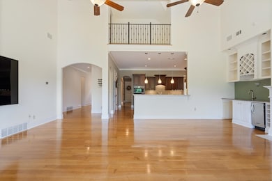 Unfurnished living room with a towering ceiling, s