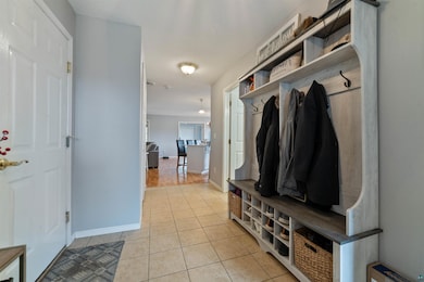 Mudroom featuring light tile patterned flooring an