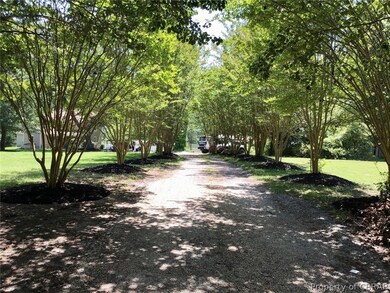 Enter the Crepe Myrtle tree lined driveway to this