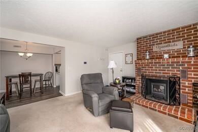 Living room featuring a textured ceiling, a chande