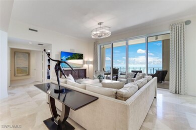 Living room with ornamental molding, a chandelier,