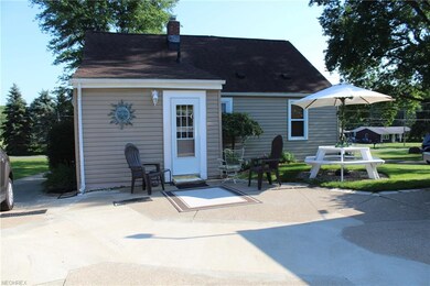 Back of home with patio and picnic area.