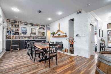 Dining area with visible vents, a fireplace, and w