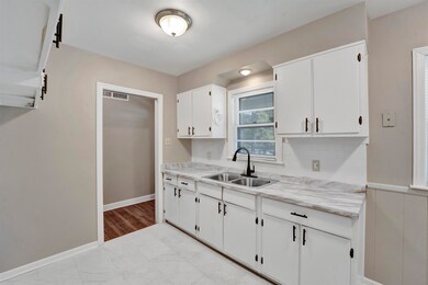Kitchen with sink and white cabinetry