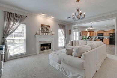 This Great Room shows the open concept of this home, serving as the center for family activities. Blinds and beautiful curtains already adorn the windows.