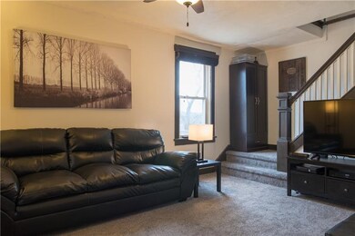 Living room with newer carpeting.