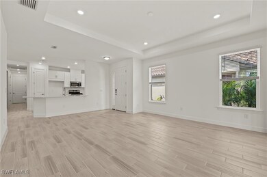 Unfurnished living room with a raised ceiling, bas