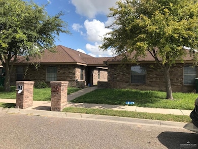Ranch-style home featuring brick siding, roof with shingles, and a front yard