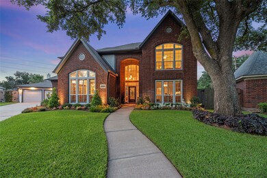 Stunning 2-story brick home with a detached 3-car
