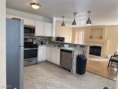 Kitchen featuring stainless steel appliances, back