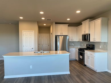 Kitchen with stainless steel appliances, a sink, 