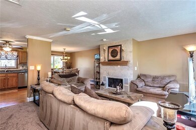 Family room features a wood burning fireplace with