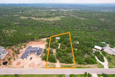 Birds eye view of property with a wooded view