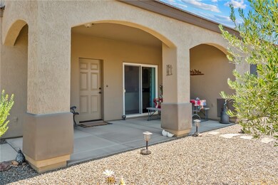 View of exterior entry with stucco siding and a pa