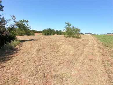 SW edge, nearest woodline, closest to pond, facing