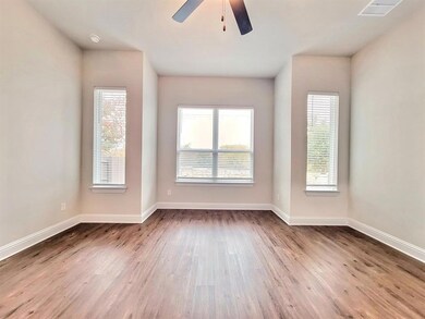 Empty room with light wood finished floors and ceiling fan