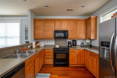 42 inch cabinets w/pull out drawers in lower cabinets, dual SS bowl sink, SS/black dishwasher, flat top range w/oven below, builtin microwave, plenty of cabinet & Counter space, nice window w/view of back yard, plus side by side SS w/water/ice on doo