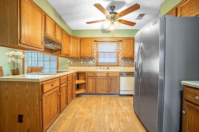 Kitchen featuring sink, stainless steel fridge, li