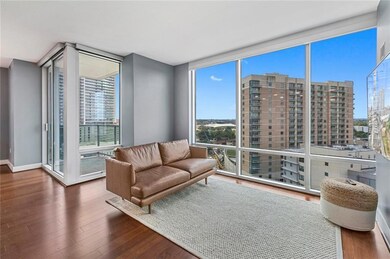 Living room featuring floor to ceiling windows, w