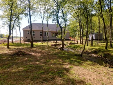 Rambling creek and lots of trees add to the park like feel of this property!