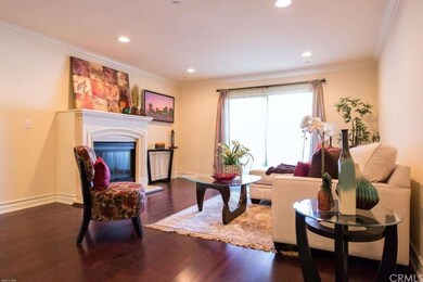 Living area with rich wood floor, fire place, rece