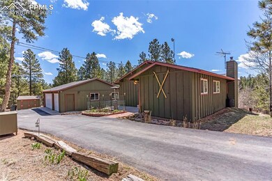 View of side of property featuring an outdoor stru