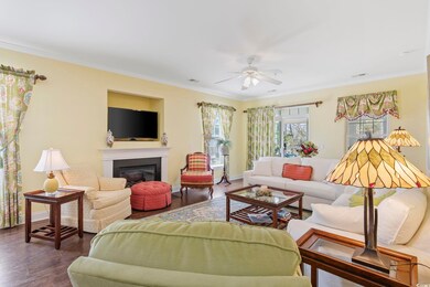 Living area with ornamental molding, wood finished
