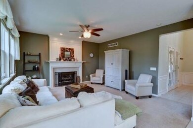 Family Room. Fireplace with Gas Logs and Large Windows Overlooking the Fenced Backyard