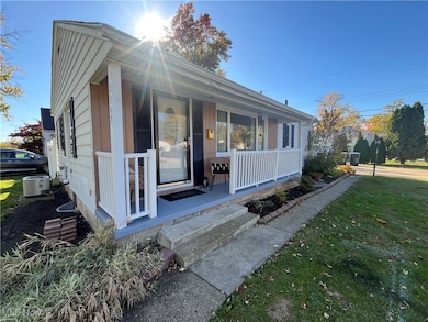 View of front facade featuring a porch and a front lawn
