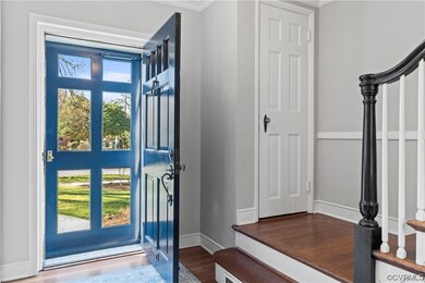 Foyer entrance with dark hardwood / wood-style floors and ornamental molding