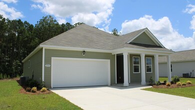 View of front of home with a garage, a front lawn,