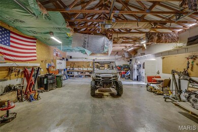 Garage with a workshop area and a garage door opener