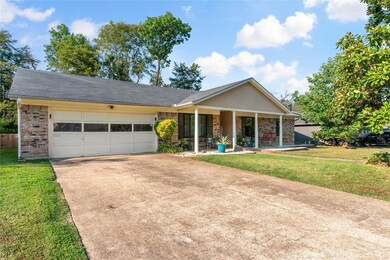 Ranch-style home with a garage and a front lawn
