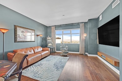 Living area featuring baseboards and wood finished