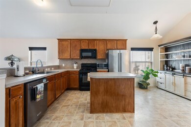 Kitchen with black appliances, tasteful backsplas