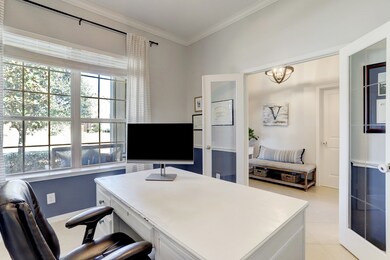 Can you picture yourself working in this office with the large picture window and all of the natural light? The room also has an updated ceiling fan and crown molding.