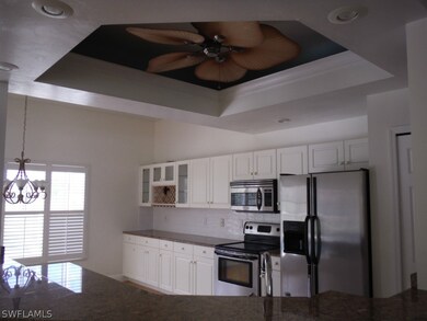 Kitchen boasts tray ceiling, granite countertops and stainless appliances