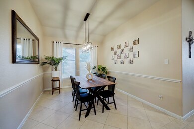 Formal Dining room is spacious with beautiful drop down pendent lighting.