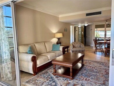 Living room with tile patterned floors and crown m